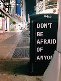 a sign that says don't be afraid of anyone